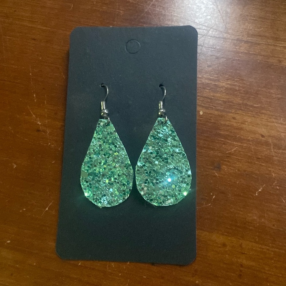 Green sparkly earring. Leather. Very light weight. Never worn. Great condition.